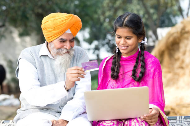 istock Old man with children using laptop and credit card 934847304