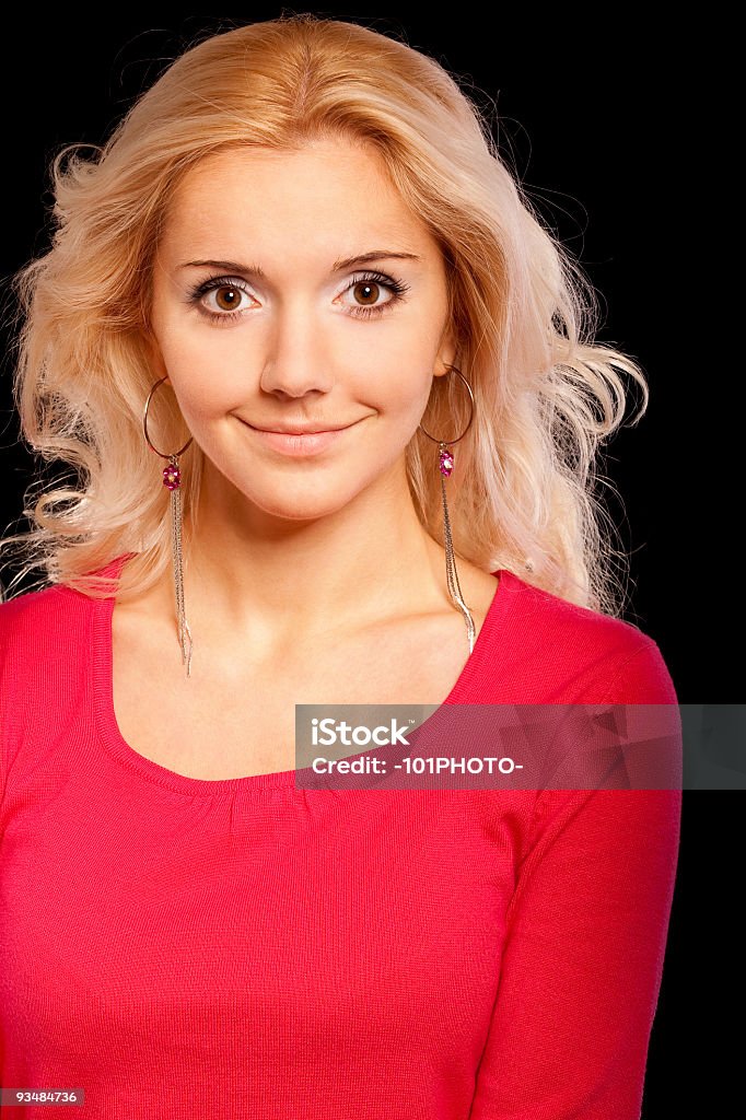 Portrait of beautiful fair-haired girl Charming girl with beautiful hair smiles, it is isolated on black background. Adult Stock Photo
