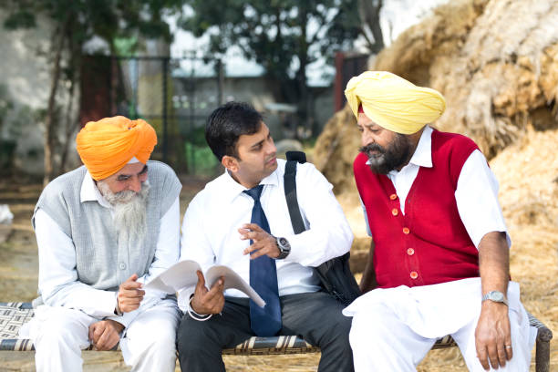 istock Salesperson explaining contract to farmers 934849606