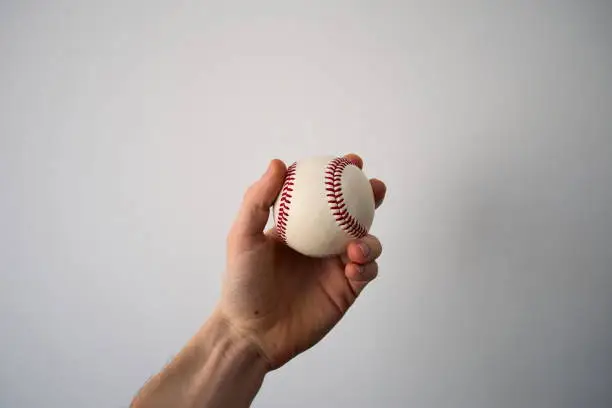 Photo of Hand holding baseball ball
