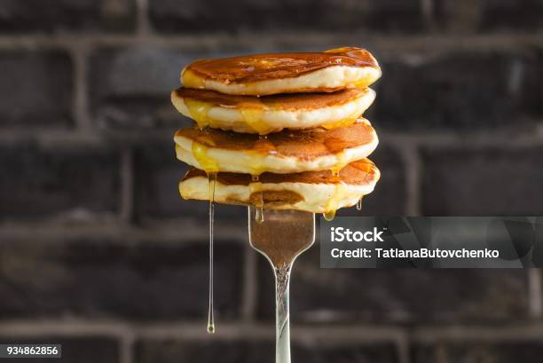 Pancake With Liquid Honey On Brick Background Selective Focus Stock Photo - Download Image Now