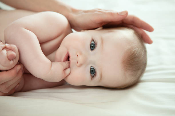 mother with a small child close-up portrait of baby boy and his mother tooth in hand stock pictures, royalty-free photos & images