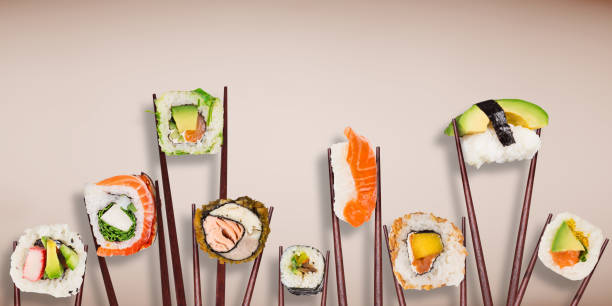 istock Traditional japanese sushi pieces placed between chopsticks on pastel color background 934866544
