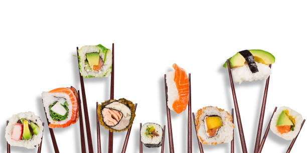 Traditional japanese sushi pieces placed between chopsticks, separated on white background
