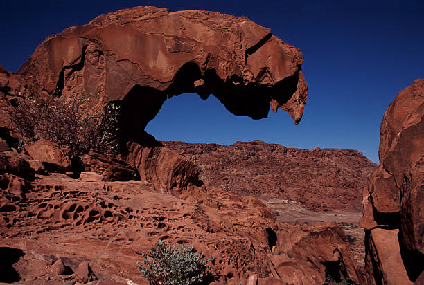 Soft pastel colors over a natural rock arch at Spitzkoppe, Namibia at dusk
