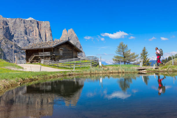 istock Hiker at Alpe di Siusi, in Springtime with Mount Schlern 934874066