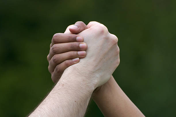 istock male and female hands clasped, multi-ethnic concept 93487431
