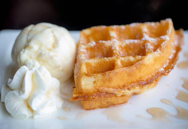 istock waffle and vanilla ice cream two scoops and maple syrup. 934877062