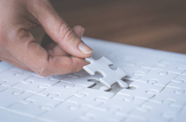 istock Hand placing the last jigsaw for business solution concept 934878096
