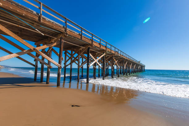 istock Waves crashing under a wooden pier 934890084
