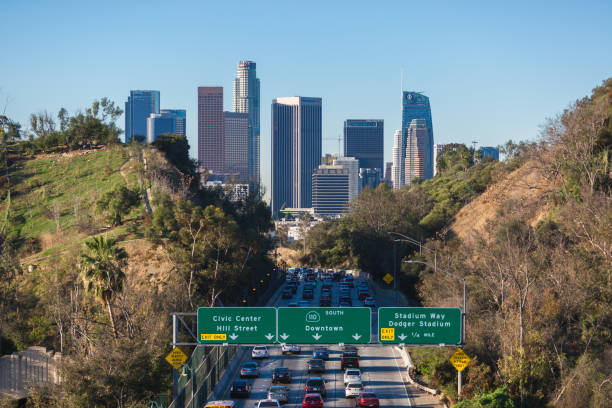 istock Los Angeles skyline with freeway traffic and signs 934890642