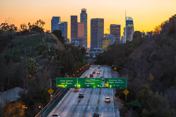 istock Los Angeles skyline with freeway traffic and signs long exposure 934890886