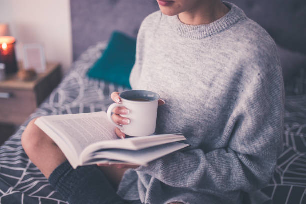 istock Enjoying a good book and coffe in bed 934896570