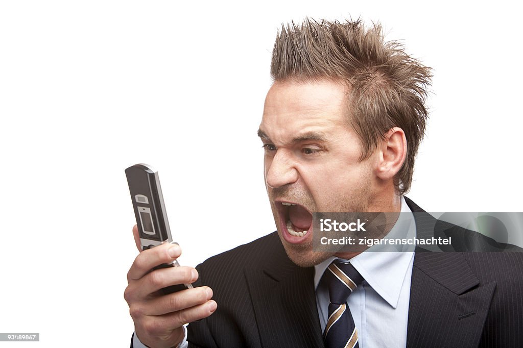 A stressed, young businessman screaming into phone Stressed young businessman screams in telephone. Isolated on white.  30-39 Years Stock Photo