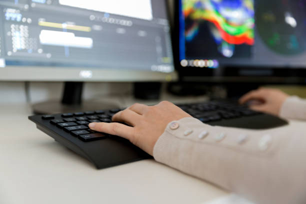 istock Female video editor works with footage on her personal computer, she works in creative office studio. Video editing 934900240