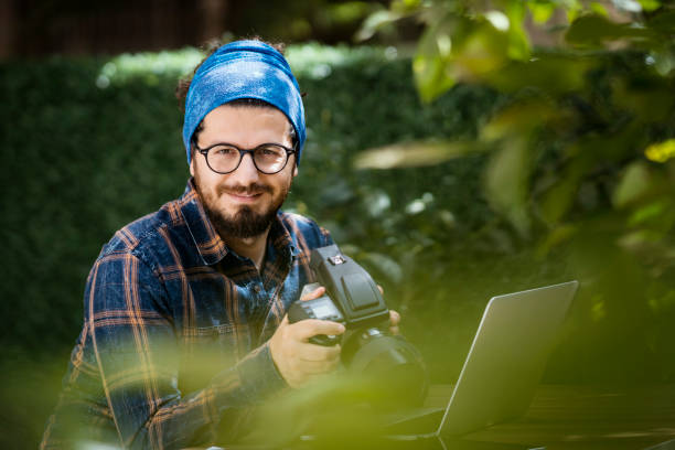 istock Photographer working on laptop, outdoors 934903508