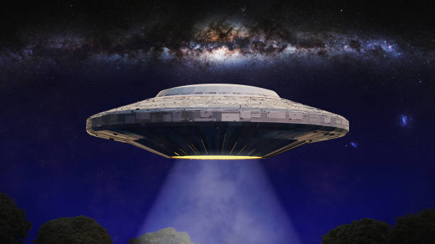istock UFO, alien spaceship with light beam hovering in night sky, extraterrestrial visitors with flying saucer (3d rendering) 934909822