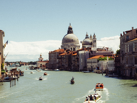 Amazing view on the beautiful Venice, Italy. Many gondolas sailing down one of the canals