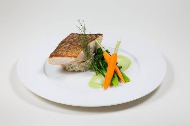 istock Line Fish with carrots and broccoli on a white plate on a white background 934922288