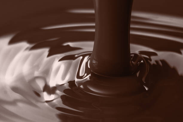 istock Pouring liquid hot chocolate closeup. Cooking dessert. 934922588