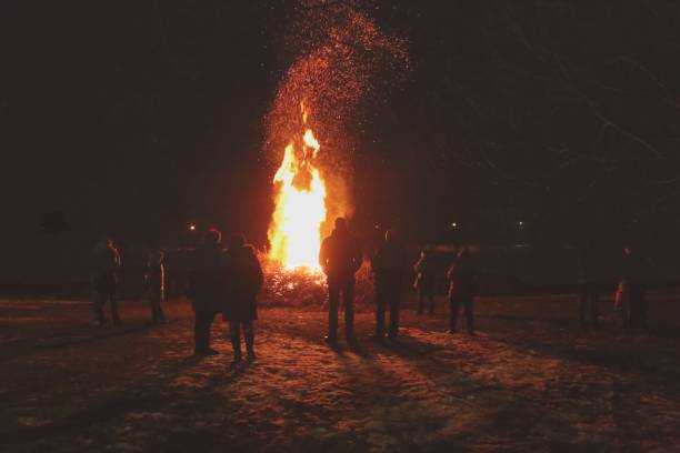 istock Silhouette of people by the fire at night. 934922746