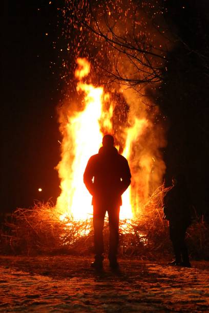 istock Silhouette of man by the fire at night. 934922784