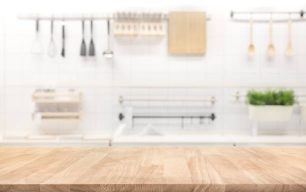 Wood table top on blur kitchen room background