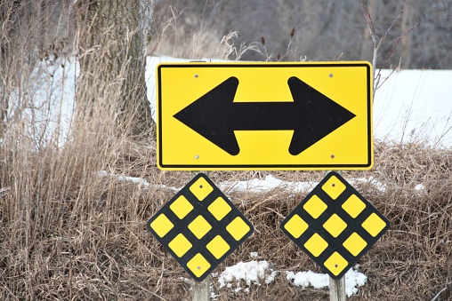 Dead End sign with arrows pointing both ways, plus two reflective signs below.