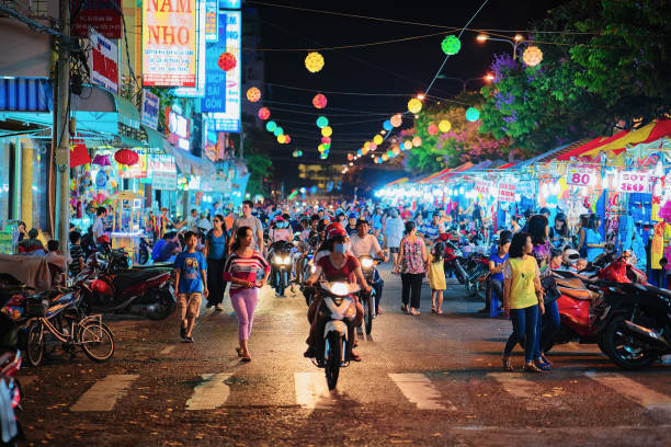 People on Street market in Can Tho at night Can Tho, Vietnam - February 27, 2016: People on the Street market in Can Tho, Vietnam, at night. Blurred focus night market stock pictures, royalty-free photos & images