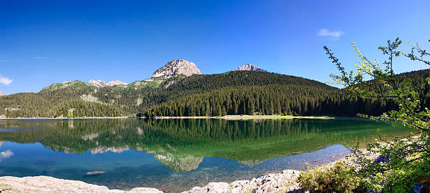 istock panorama of mountain lake over blue sky 93494673