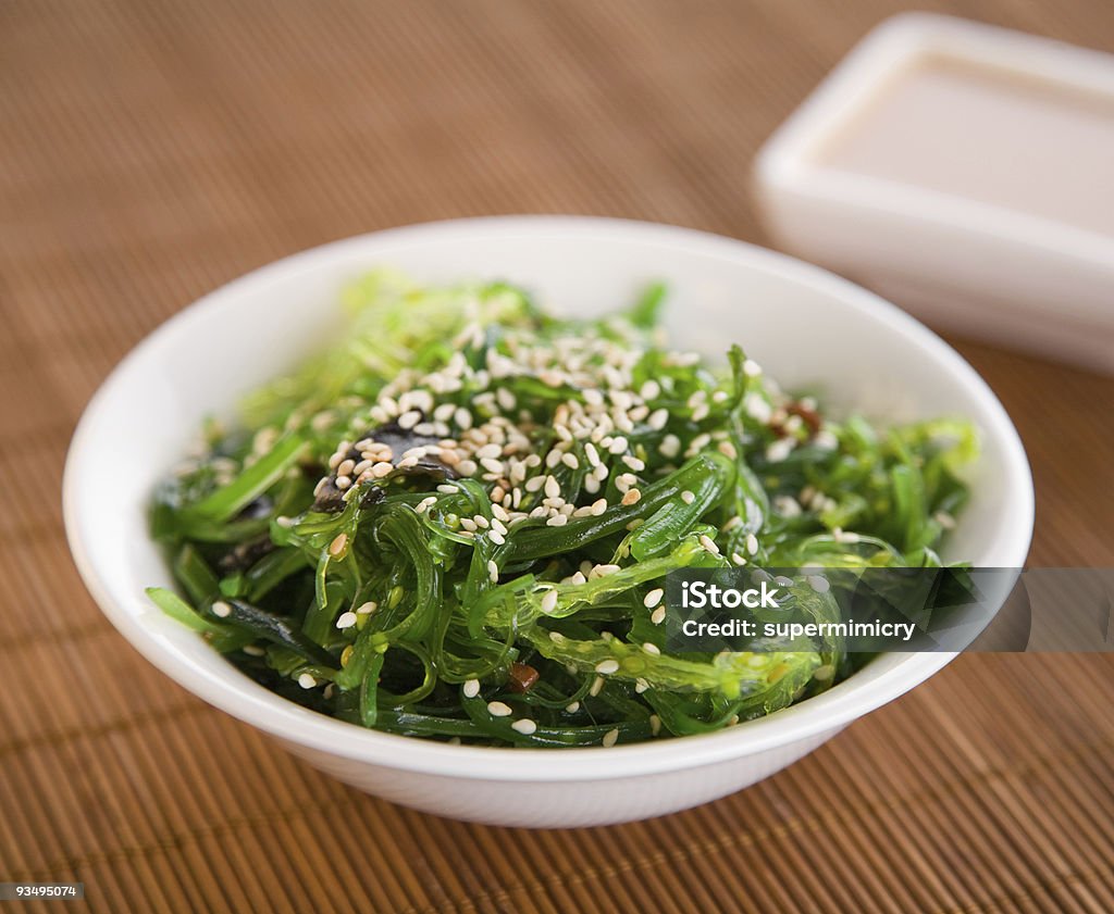 Wakame Seaweed Salad Wakame seaweed salad with nut sauce, garnished with sesame seeds and red chili pepper Salad Stock Photo