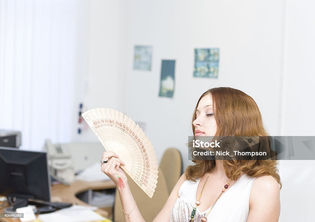 Girl in office brush away face by fan  Adult Stock Photo