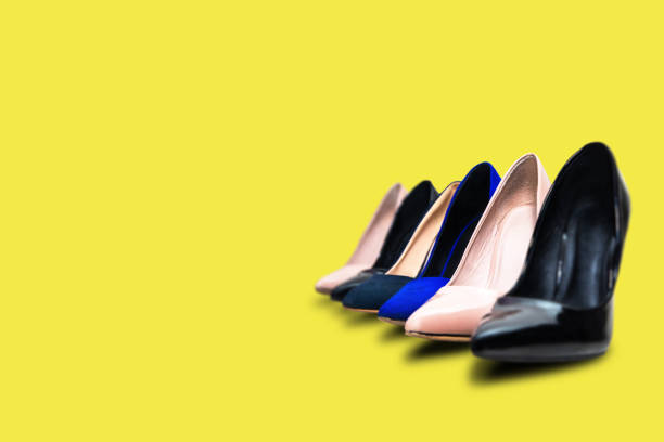 istock High heels footwear on a yellow pastel background. 934957100