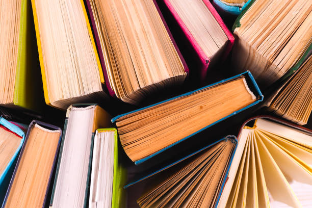 istock Open book, hardback books on bright colorful background. 934963080