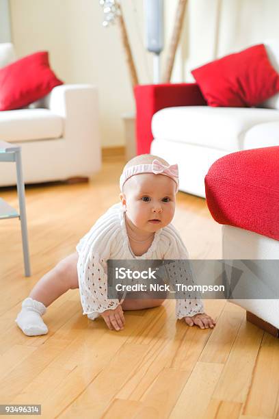 Happy Baby Girl Crawling On A Hardwood Floor Stock Photo - Download Image Now - 6-11 Months, Babies Only, Baby - Human Age