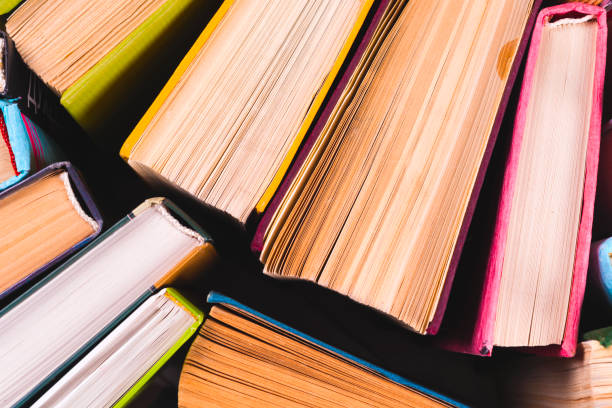 istock Open book, hardback books on bright colorful background. 934964076