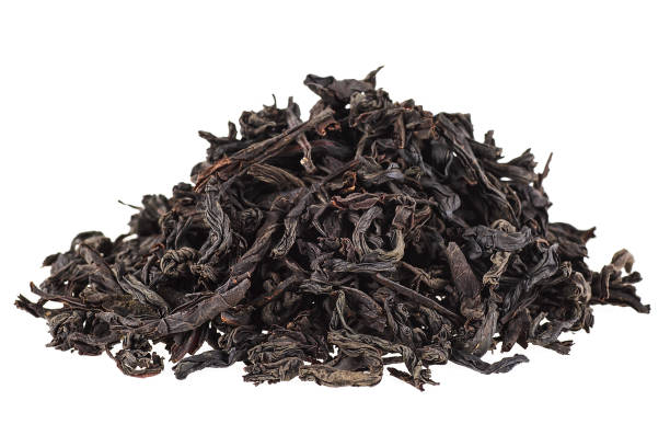 istock Dry black tea leaves isolated on white background 934977706