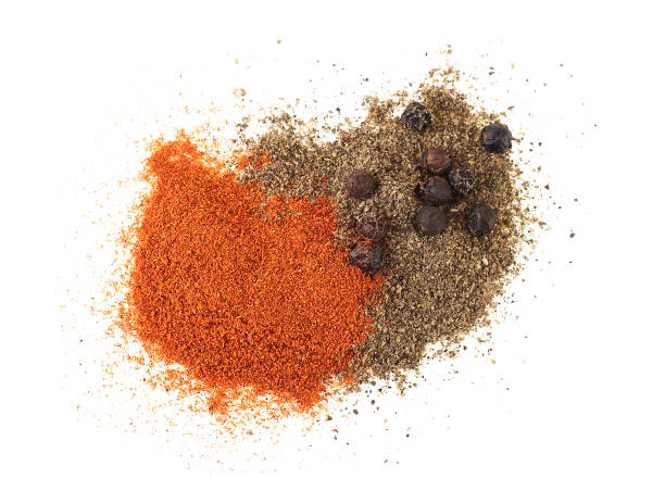 istock Powder of black and red pepper on a white background. Top view. 934980944