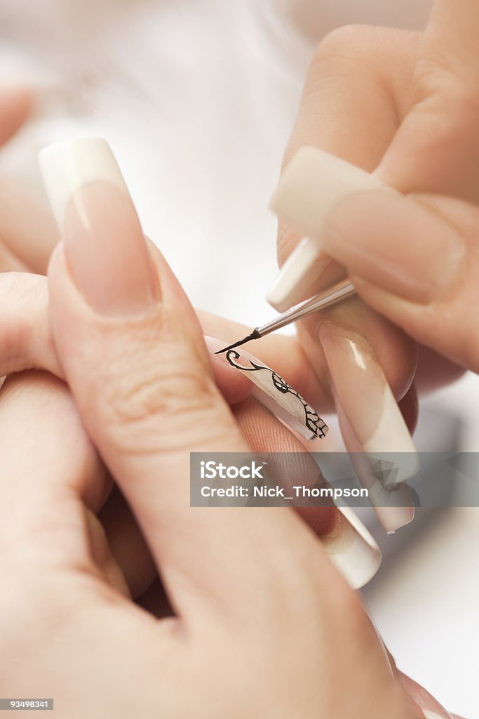 Beauty salon: Manicure, painting on nail  Acrylic Painting Stock Photo