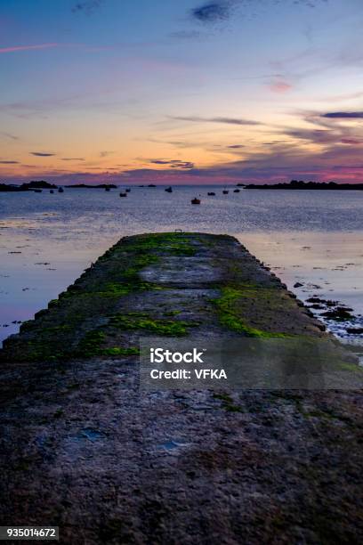Sunset At Cobo Bay Landing Stage Pier Made Of Concrete Grandes Rocques Guernsey Channel Islands Stock Photo - Download Image Now