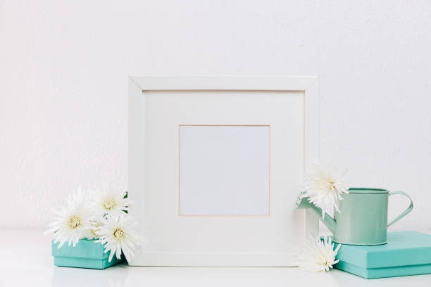 istock Mock Up white frame with spring flowers and turquoise accessories 935023848