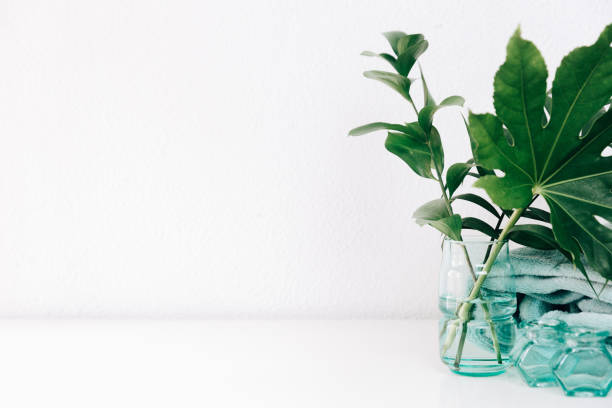 istock Minimal home decor with copy space. Green leaves in vase 935023852