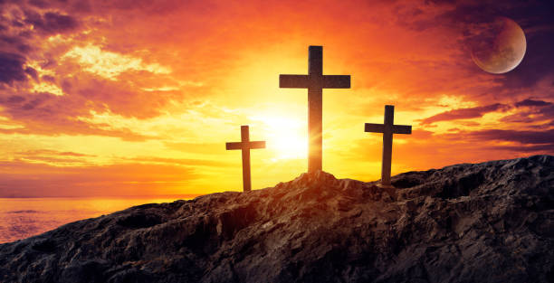 istock Silhouetted christian cross silhouette on the mountain at sunset 935028302