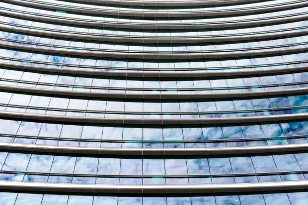 istock Skyscraper glass wall with reflection of sky and clouds 935028878