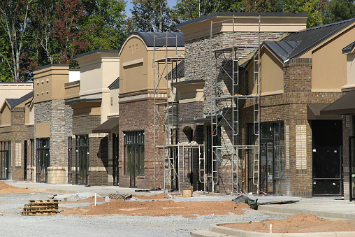A suburban shopping center under construction, designed to look like a small town main street.
