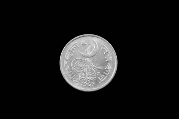 istock Old Pakistani One Rupee Coin Isolated On Black 935034824