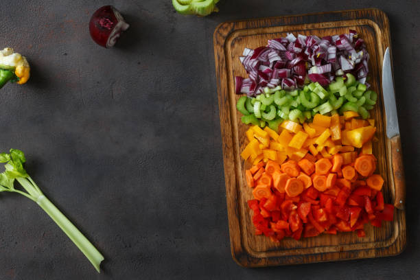 istock Frame of chopped fresh vegetables arranged on cutting board on dark background, top view 935034964