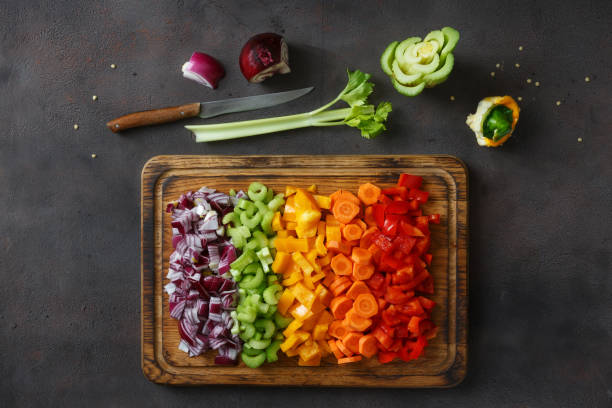 istock Top view chopped vegetables serving on cutting board on dark background 935035016