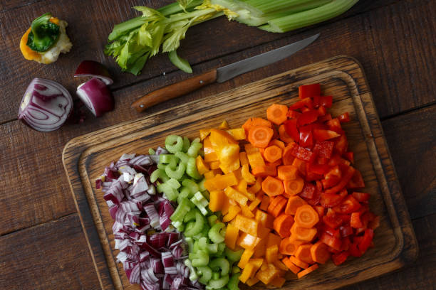 istock Top view chopped vegetables arranged on cutting board on wooden table 935035060