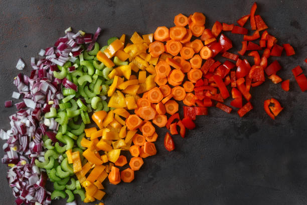 istock Top view chopped fresh vegetables on dark background 935035206